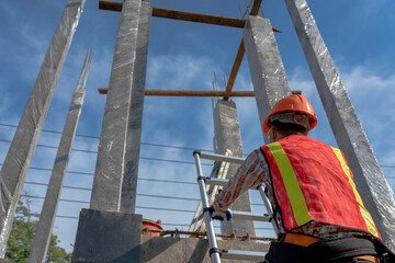 Backside worker in uniform at the construction site