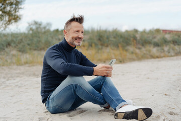 Attractive casual athletic man relaxing at the beach
