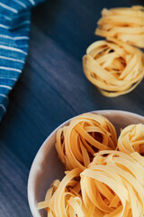 Pasta dish with a handful of raw tagliatelle