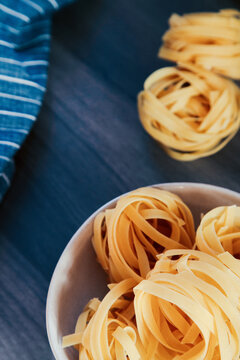 Pasta Dish With A Handful Of Raw Tagliatelle