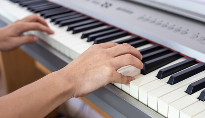 Fototapeta na wymiar Musician playing piano and the hands on the piano keys