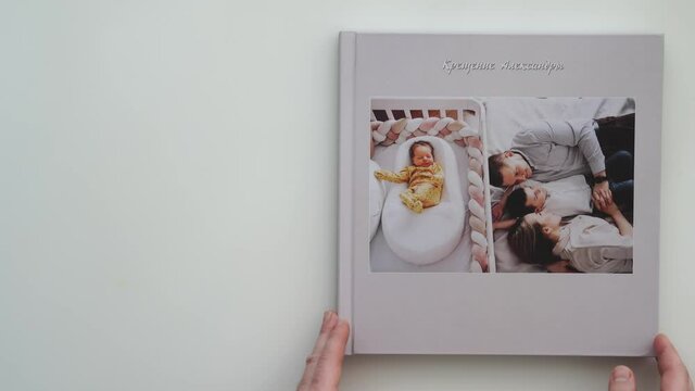 on white table photobook from photo shoot of family with newborn.
