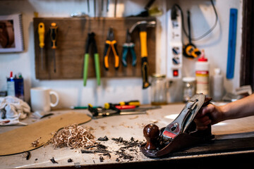 Unrecognized luthier woman in traditional workshop