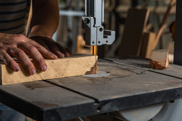 A carpenter works on woodworking the machine tool. Carpenter working on woodworking machines in...