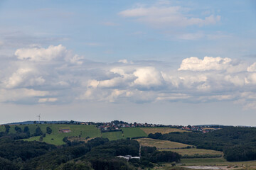 a beautiful landscape with fields, villages, a blue sky and white clouds. 