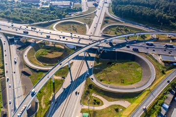 panoramic view of the motorway junction and fast moving cars filmed from a drone 