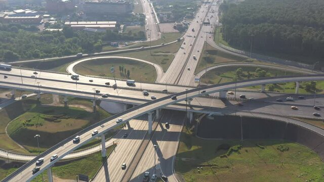 panoramic view of the motorway junction and fast moving cars filmed from a drone 