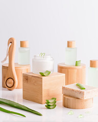 Fototapeta na wymiar Natural cosmetics with aloe vera on wooden podiums in reusable bottles