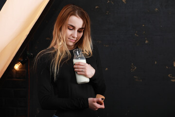 Young girl drinks milk from a bottle