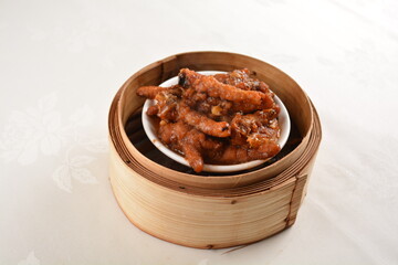 steamed chinese marinated chicken claw feet in bamboo basket Hong Kong dim sum snack menu