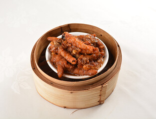 steamed chinese marinated chicken claw feet in bamboo basket Hong Kong dim sum snack menu