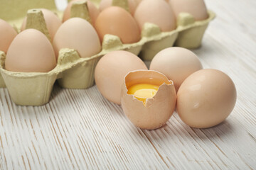 Close-up view of raw chicken eggs in egg box on wooden background. Raw chicken eggs in egg box organic food for good health high protein .