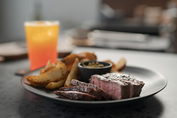 Grilled beef steak with roasted potatoes and pesto sauce