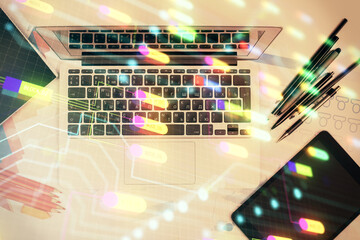 Multi exposure of data drawing hologram over topview of study desk background with computer. Concept of technology.