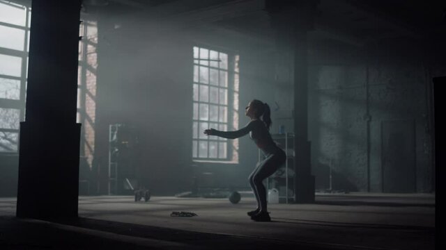 Woman doing deep squats. Sporty girl performing sit ups during training