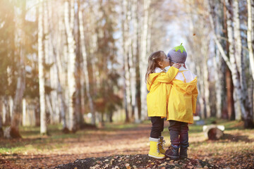 Children walk in the autumn park