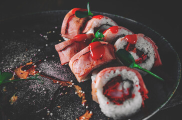 sushi roll in plate on black wooden table background