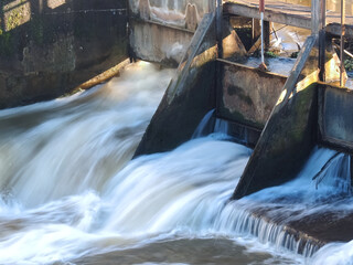 Flowing blurred water in a weir in Grevenbroich in Germany