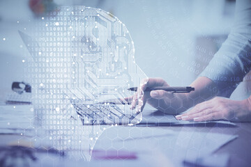 Multi exposure of woman hands working on computer and brain hologram drawing. Ai concept.