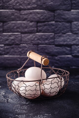 Fresh raw eggs in a metal basket.