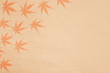 秋イメージ背景素材（複数のモミジの葉と茶色い和紙）