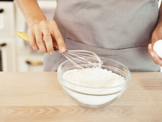 Woman Hand Mixed Batter on Clear Bowl with Baloon Whisk Step by Step Baking Preparation in the Kitchen