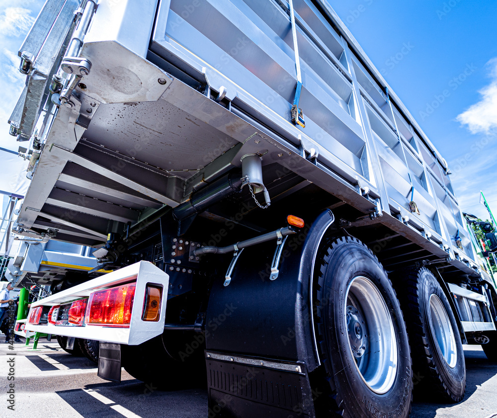 Wall mural large grain trucks at the blue sky background