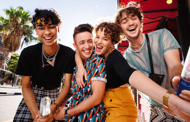 Carefree friends celebrating with confetti outdoors