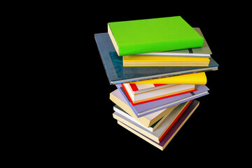 Stack of colorful  books isolated on black background