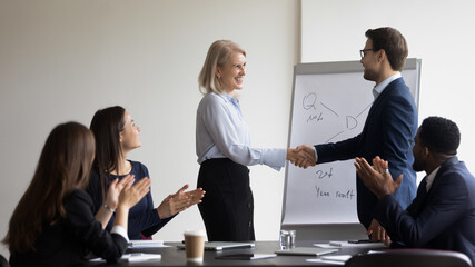 Businessman thanking mature mentor for training course. Boss, team leader expressing respect,...