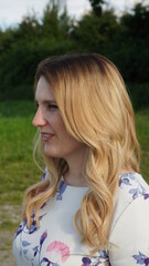 blond girl, woman with tape in extensions and balayage looking into camera