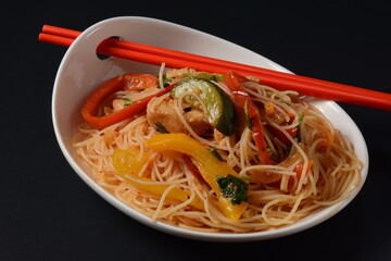 Japchae, Korean Glass noodle stir fry. Funchoza salad. Glass noodles salad with fresh vegetables: carrot, bell pepper, cucumber, with sesame seeds, coriander seeds, hot pepper, soya sauce.