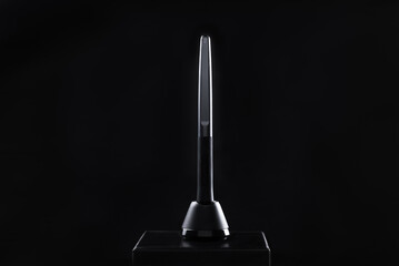 Digital pen on a black background. Graphic tablet stylus in stand on black background isolated. Digital pen for drawing in graphics programs. Contemporary art