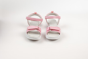 Pink insulated sandals. Children's pink sandals with white soles and Velcro fasteners isolated on a white background. Fashionable children's shoes for children. 