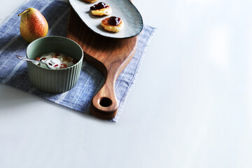 Morning breakfast with cheesecake, yoghurt and pea in the corner of table on a napkin. Sirniki is Russian cheesecake.