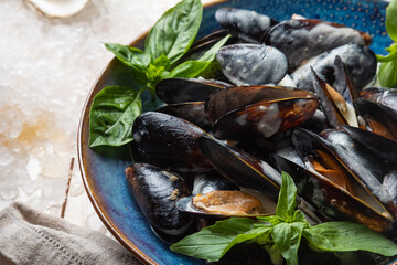 mussels in a creamy sauce garnished with basil leaves