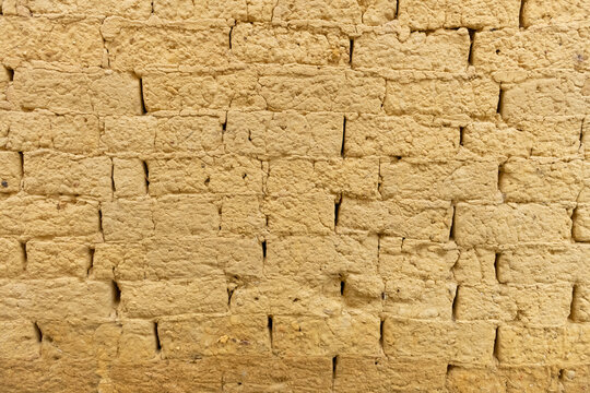 wall made of mud bricks as background and texture