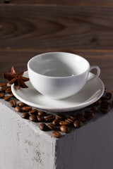 Empty cup of coffee and beans on concrete grey cube as  background texture.  Abstract break concept