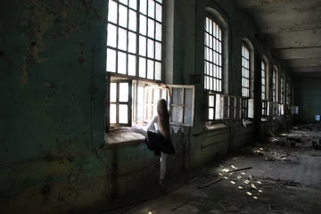 Fotobehang Long hair ballet dancer woman dance near window in old abandoned factory © Natalya