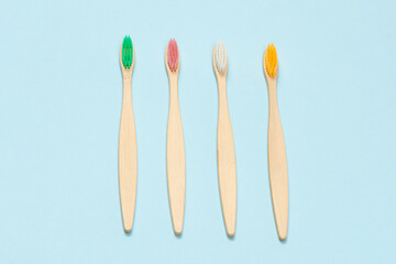 Bamboo toothbrush on a blue background. Top view.