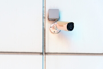 video surveillance cameras installed on the white wall at the entrance to the supermarket. Security and anti-theft systems. Protection of personal property and protection of private territory.