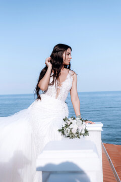 luxurious young bride in an expensive fashionable wardrobe poses for a wedding photo shoot in a luxury resort town