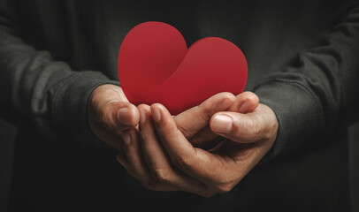 Love, Health Care, Donation and Charity Concept. Close up of Volunteer Holding a Heart Shape Paper - obrazy, fototapety, plakaty