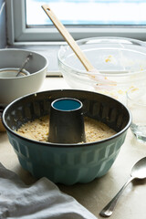 Cooking bundt cake in bundt tin metal pan, raw dough for cake