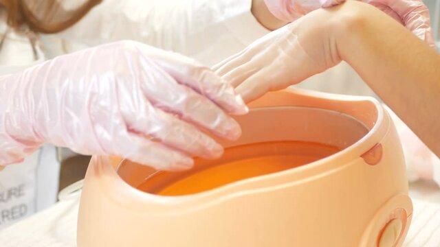 Paraffin bath. Spa Salon. Manicure. Process paraffin treatment.