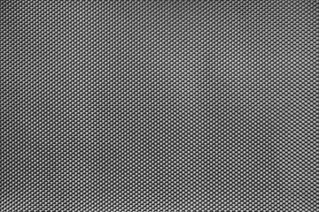 black and white textured background or wallpaper made of synthetic fabric close-up