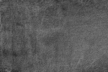 Fototapeta na wymiar dark spotted texture of old denim in black and gray