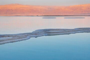 Sunset at the Dead Sea. Salt formations. Mountain range