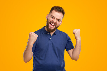Excited bearded man celebrating victory
