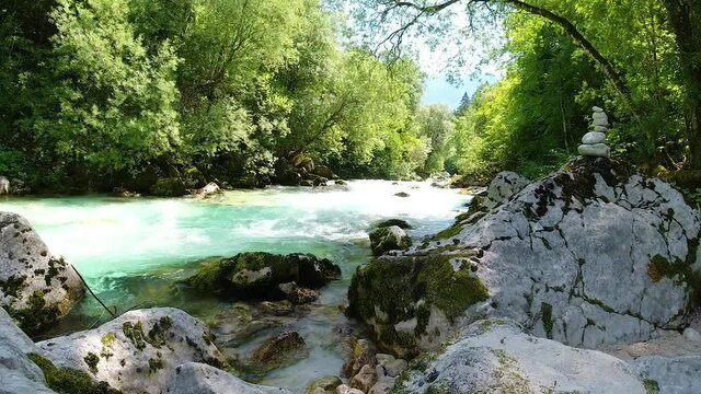 Soca river valley cascades in Slovenia with stone cairn